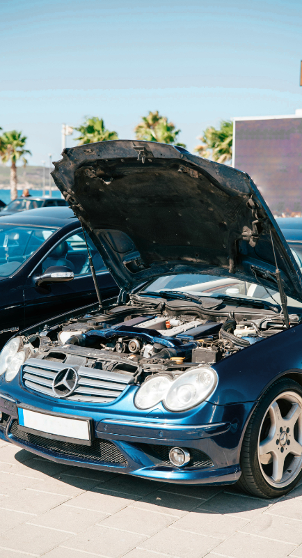 blue mercedes-benz with the hood up
